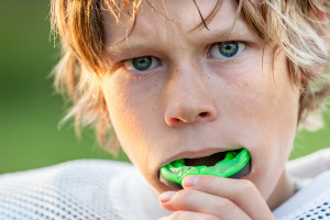 Boy putting in his mouth guard